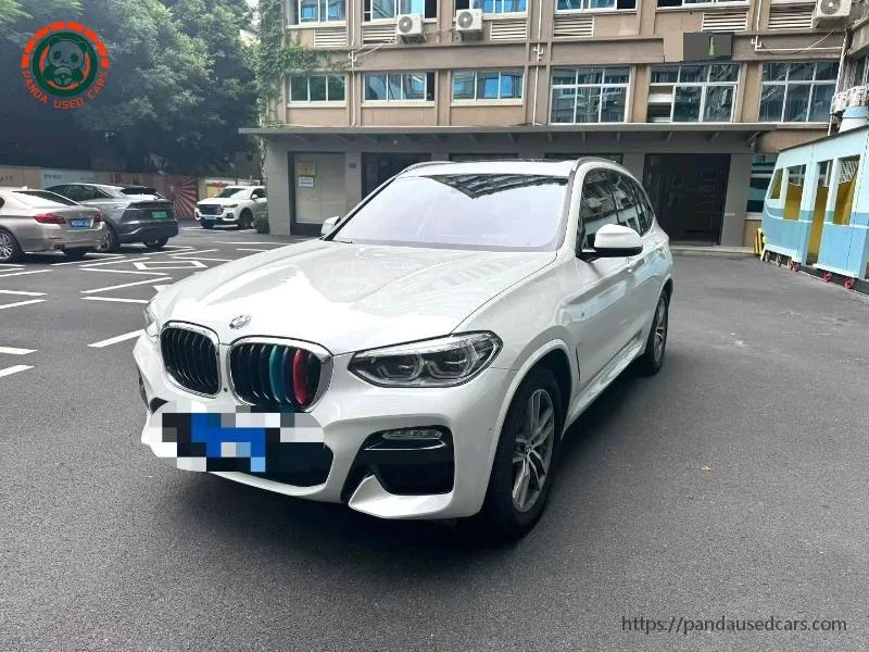 White BMW X3, front three-quarter view in a parking area